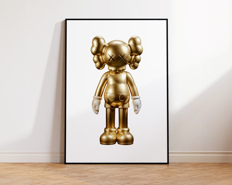 May include: A gold-coloured figurine of a cartoon character with white hands and a black X for eyes. The figurine is standing on a white background.