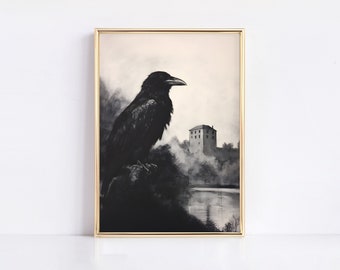 May include: A framed wall art print featuring a black raven perched on a dark branch in the foreground. The background displays a monochromatic landscape with a distant stone building and a body of water under a pale, overcast sky.