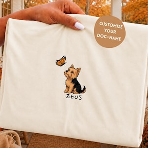 Folded IVORY Comfort Colors shirt with cute Yorkshire Terrier puppy and butterfly graphic, personalized dog lover tee with custom pet name, minimalist pet shirt flat lay aesthetic gift idea.