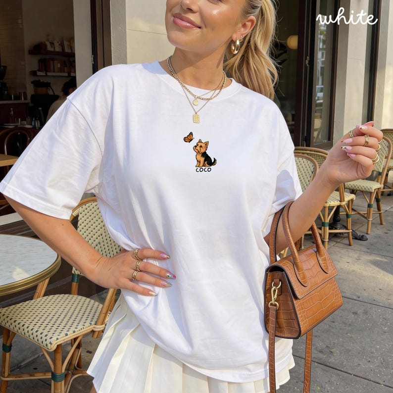 Folded WHITE Comfort Colors shirt with cute Yorkshire Terrier puppy and butterfly graphic, personalized dog lover tee with custom pet name, minimalist pet shirt flat lay aesthetic gift idea.