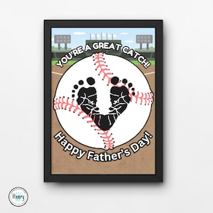 May include: A white baseball with black footprints in the shape of a heart. The baseball is on a brown background with the text "You're a Great Catch! Happy Father's Day!"