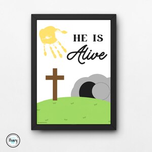 May include: A white printable Easter art print with a yellow handprint, a brown cross, a grey stone tomb, and green grass. The text "HE IS ALIVE" is written in black cursive.