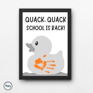 May include: Framed print featuring a gray duck with an orange handprint and the text "QUACK. QUACK SCHOOL IS BACK!". The duck is set against a white background, with a black frame. A fun, back-to-school themed art print.