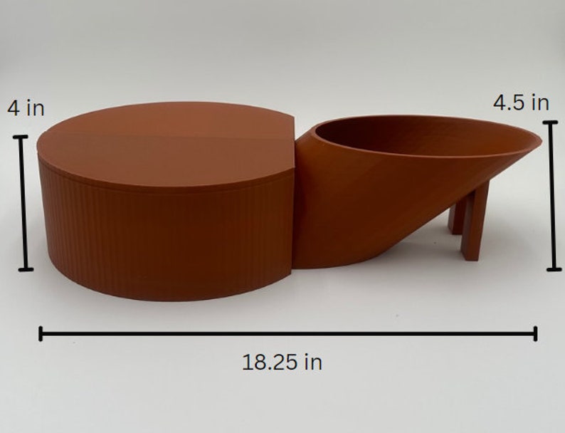 May include: A terracotta-colored ceramic planter with a cylindrical base and a curved, angled spout. The planter measures 4 inches tall and 18.25 inches wide. The spout is 4.5 inches tall.