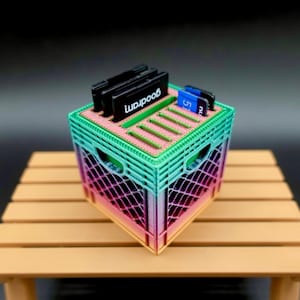May include: A rainbow-colored plastic crate with a green top and a pink bottom. The crate is filled with SD cards and memory cards. The text "wapood" is printed on one of the memory cards.