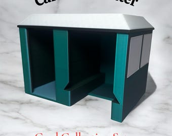 May include: A teal and white card collecting setup with the text "CardCare Center" and "Card Collecting Setup". The structure has multiple compartments and a roof, designed for organizing and displaying trading cards.