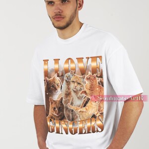May include: White t-shirt with a graphic print of orange tabby cats and the text "I LOVE GINGERS".