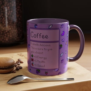 May include: A purple coffee mug with a matching handle, featuring the word "Coffee" in pixelated font. The mug includes text stating "It smells delicious. This is sure to give you a boost." and lists energy, health, and speed boosts.