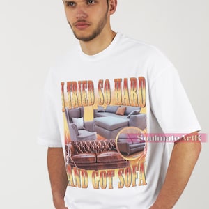 May include: White t-shirt with a graphic print of three sofas and the text "I tried so hard and got sofa".