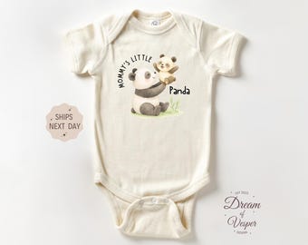 May include: Cream-colored baby onesie with a panda bear illustration. The design features a large panda holding a smaller panda, with the text "Mommy's Little Panda". The onesie is made of soft material.