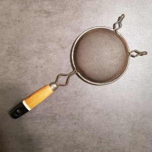Vintage Metal Strainer with Yellow and Black Wooden Handle