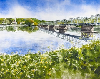 May include: A watercolor painting of a green metal bridge over a river with a small town in the background. The bridge is reflected in the water. There are yellow flowers in the foreground.