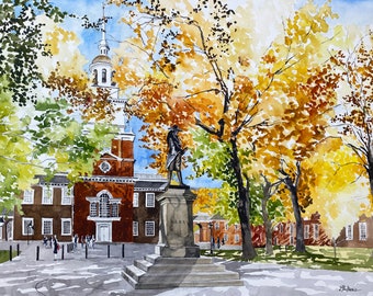 May include: A watercolor painting of a historic building with a statue in front of it. The building is red brick with white trim and a tall steeple. The statue is of a man in a long coat and hat. The scene is set in a park with trees in autumn colors.