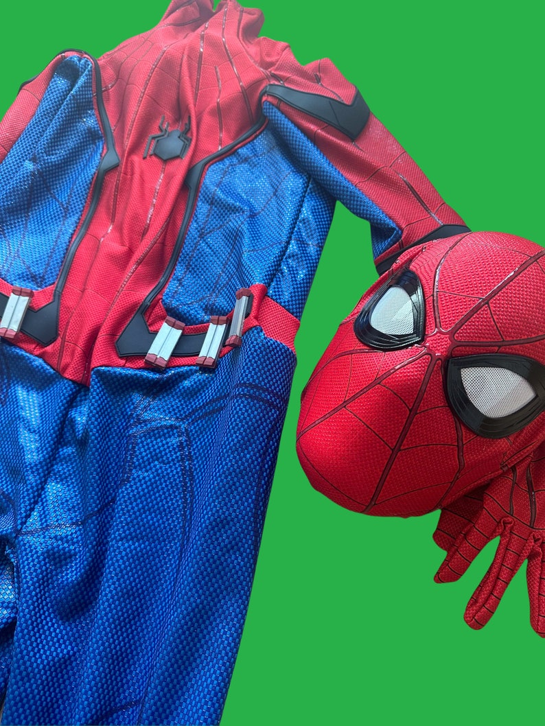 May include: A red and blue Spiderman costume with a red mask. The costume has a spider logo on the chest and a web pattern throughout. The mask has a black eye area and a web pattern on the outside.