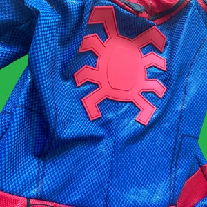 May include: Blue and red Spiderman costume with a large red spider logo on the back. The costume has a textured fabric.