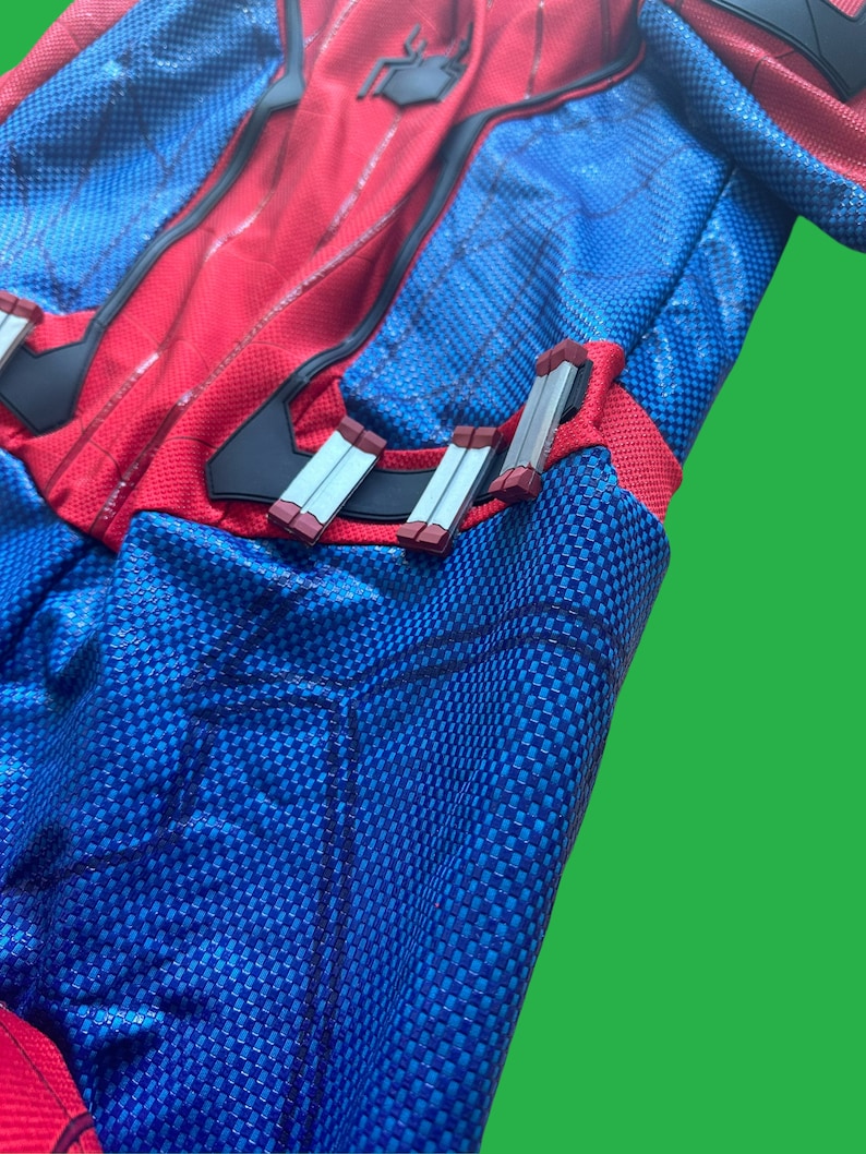 May include: A red and blue spandex costume with a spider logo on the chest. The costume has a black web pattern and silver and red accents on the waist.