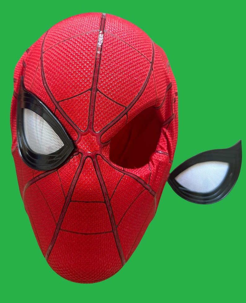 May include: Red and black Spider-Man mask with a white mesh eye piece. The mask is made of fabric and has a textured surface.