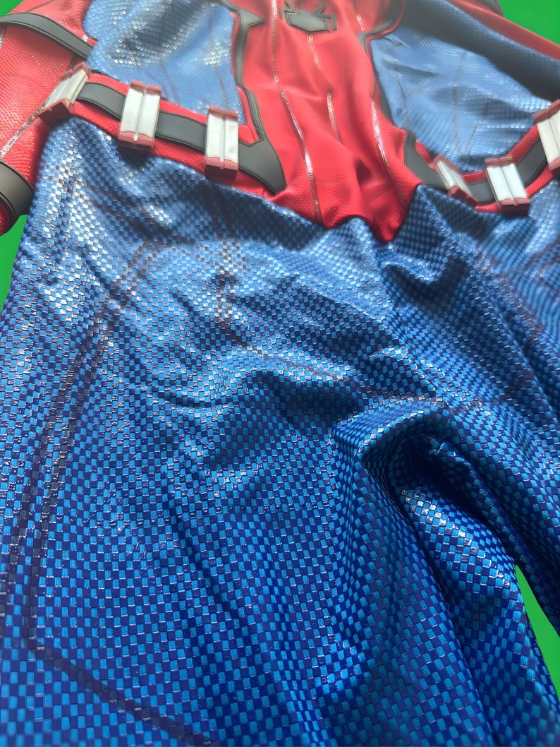 May include: Blue and red fabric with a checkered pattern. The fabric is wrinkled and has a shiny finish.