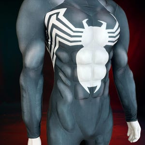 May include: A black and white Venom-themed bodysuit. The costume features a high collar, long sleeves, and a detailed design mimicking the character's musculature. The chest displays a white spider emblem.