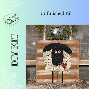 May include: A DIY kit featuring a wooden board with a sheep design made of black and white buttons. The sheep has a black button face and white button wool. A small red wooden heart is attached to the sheep. The text reads Unfinished Kit and DIY KIT.