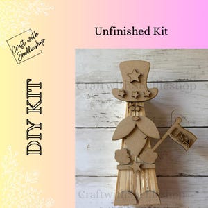 May include: Unfinished DIY kit featuring a wooden gnome with a top hat and a USA flag. The gnome has a beard and holds a flag that says "USA". The kit includes the text "DIY KIT" and "Unfinished Kit".