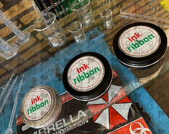 RESIDENT EVIL: Réplica de utilería - Cinta de tinta (Edición Plata)