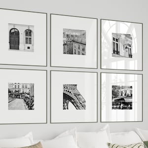 May include: Six framed black and white photographs of Parisian architecture, including building facades, the Eiffel Tower, and street scenes. The frames are dark gray, and the images are mounted on white mats.