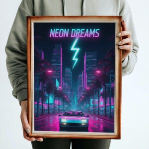 May include: Framed art print with a retro neon cityscape design. The artwork features a car driving down a road lined with palm trees and buildings, with the words "NEON DREAMS" and a lightning bolt in the sky. The color palette includes shades of pink, blue, and purple.