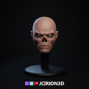 May include: A detailed, realistic sculpture of a human head with a pale, wrinkled face and intense, dark eyes. The head is mounted on a black stand against a black background.