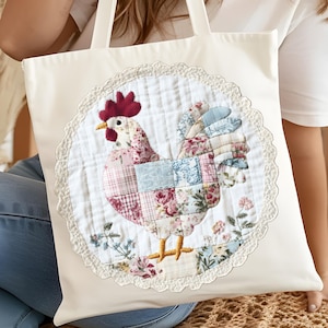 May include: Cream-colored tote bag featuring a patchwork rooster design. The rooster is made of floral patterned fabric in shades of pink, blue, and white, with a red comb and yellow feet. The design is framed by a white lace trim.