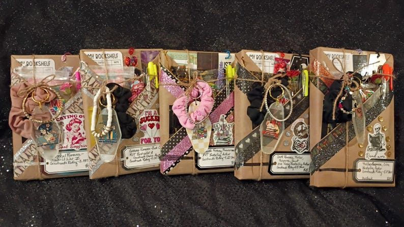 May include: Five rectangular packages wrapped in brown paper, each labeled My Bookshelf. Each package is decorated with patterned washi tape, stickers, a fabric scrunchie, a keychain, and a small tag with handwritten text, tied together with twine.