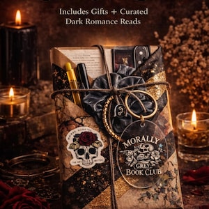 May include: A rectangular book club box wrapped in brown paper with black and gold glitter accents. It features a skull and rose sticker, a clear acrylic tag reading Morally Grey Book Club, a dark scrunchie, and two pens tied with twine.