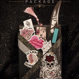 May include: A black wrapped package labeled BASIC DATE PACKAGE featuring various stickers including skulls, flowers, and text reading DARK ROMANCE. A pink tassel bookmark and a knife-shaped cutout are tucked inside. A handwritten tag lists genres.