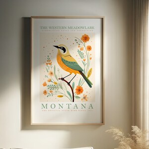 May include: A poster featuring a yellow and green Western Meadowlark bird perched on a branch with orange flowers. The text "THE WESTERN MEADOWLARK" and "MONTANA" is displayed on the poster. The text "THE OFFICIAL STATE BIRD SINCE 1931" is also included.