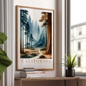 May include: A framed poster with a watercolor illustration of a forest path in Redwood National Park, California. The poster has a brown wooden frame and the text "CALIFORNIA REDWOOD NATIONAL PARK" at the bottom.
