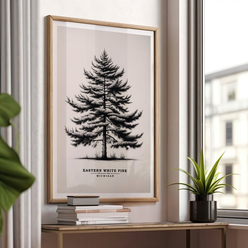 May include: A framed print of a black and white illustration of an Eastern White Pine tree, the state tree of Michigan. The print has a light pink background and the text "Eastern White Pine, The State Tree of Michigan" is printed below the tree.