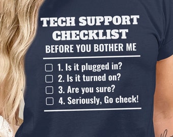 May include: A navy blue t-shirt with white text that reads "Tech Support Checklist Before You Bother Me". The text is followed by a checklist with four items: "Is it plugged in?", "Is it turned on?", "Are you sure?", and "Seriously, Go check!"