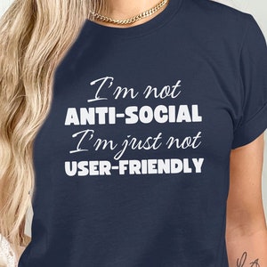 May include: A navy blue t-shirt with white text that reads "I'm not anti-social I'm just not user-friendly."