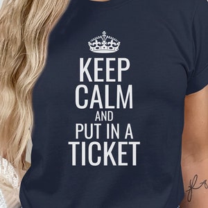 May include: A navy blue t-shirt with a white crown and the text "Keep Calm and Put in a Ticket".