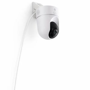 May include: A white security camera mounted on a wall. The camera has a black lens and a white cable. The brand name "eufy" is printed on the camera. The camera is designed for home security and surveillance.