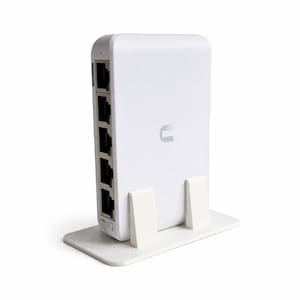 May include: A white network device with several Ethernet ports, standing on a matching white base. The device has a curved design and a small logo on the front. The ports are black.