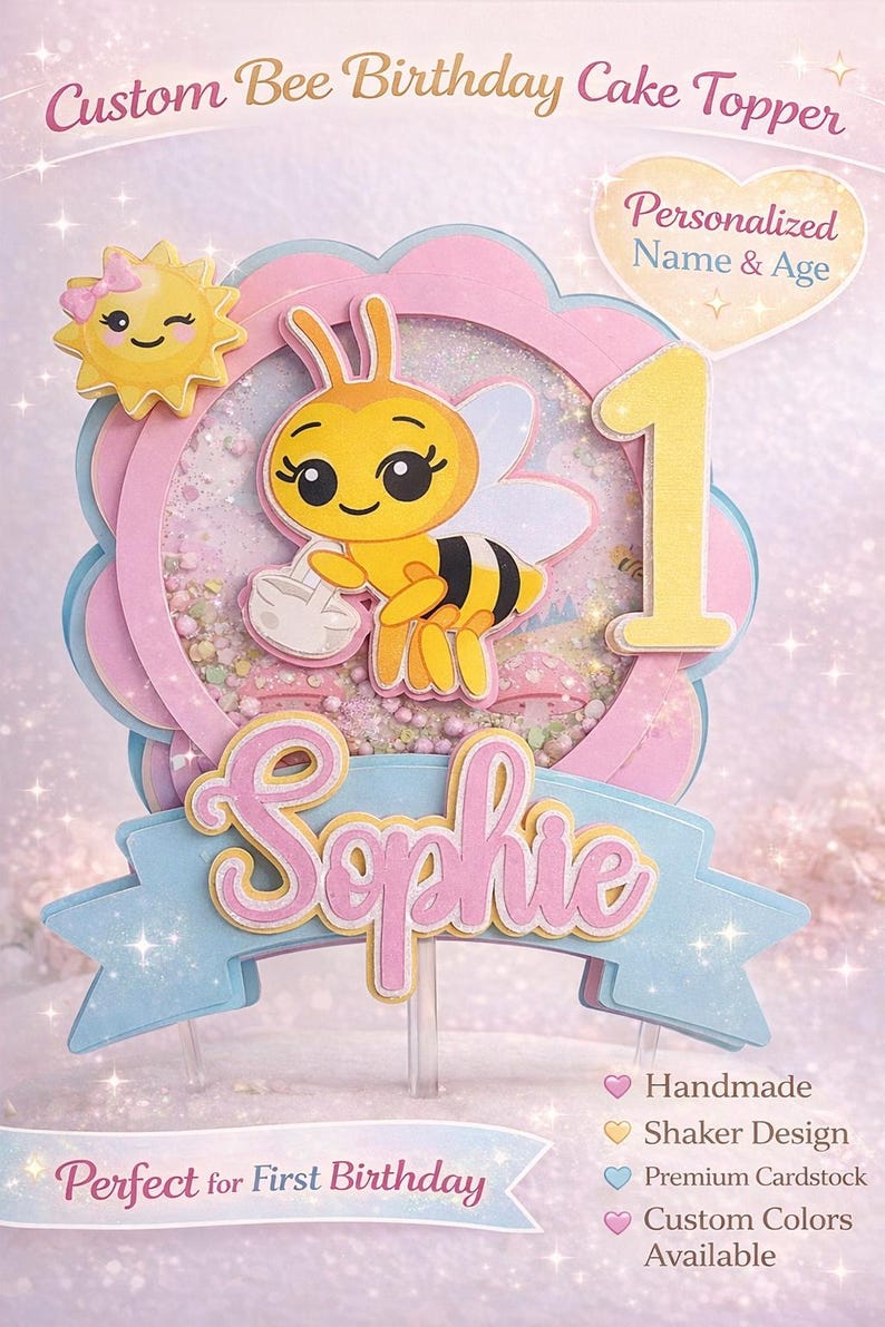 May include: A custom bee-themed birthday cake topper. The topper features a yellow bee holding a small bag, a yellow number one, and the name "Sophie" in pink. The design includes a shaker element and the text "Perfect for First Birthday".