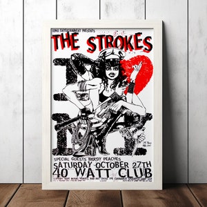 May include: A black and white concert poster advertising a show by The Strokes with special guest Moldy Peaches. The poster features a graphic illustration of a woman in a police hat and a red heart. The show is scheduled for Saturday, 27th October at the 40 Watt Club.