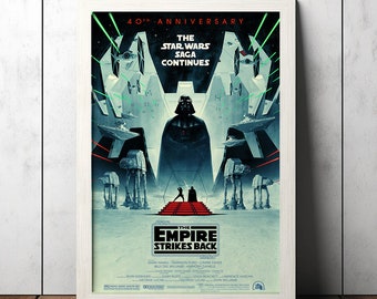 May include: Framed Star Wars: The Empire Strikes Back poster. The artwork features Darth Vader, AT-AT walkers, and TIE fighters. Text includes "40th Anniversary" and "The Star Wars Saga Continues". The poster is in a white frame, set against a wooden background.