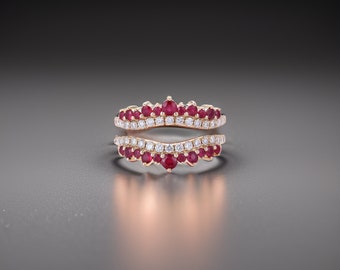 May include: A rose gold ring with a double band design. The top band is set with small round rubies and diamonds, while the bottom band is set with diamonds only. The ring is designed to be worn as a wedding band or engagement ring.