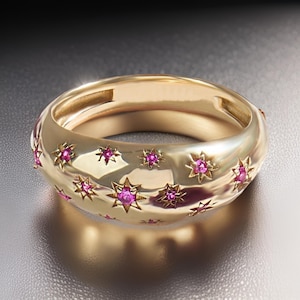 Könnte beinhalten: Ein goldener Ring mit gewölbter Oberfläche und einem Sternenmuster. Der Ring ist mit kleinen rosafarbenen Edelsteinen besetzt.