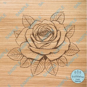 May include: A detailed line drawing of a rose with leaves on a woodgrain background. The rose is drawn in a vintage style with intricate details.