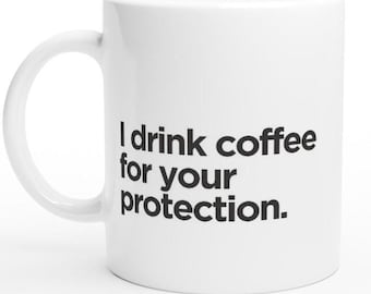 May include: White ceramic coffee mug with black text that reads "I drink coffee for your protection."