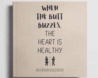 May include: A tan-colored book with the text "WHEN THE BUTT BUZZES, THE HEART IS HEALTHY" and a black and white bathroom symbol. The book is titled "BATHROOM GUESTBOOK".