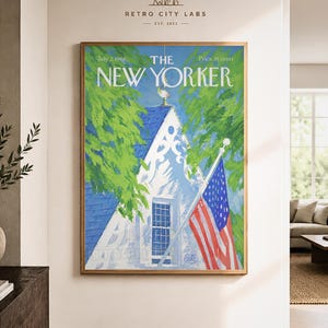 May include: A framed wall art print of The New Yorker magazine cover dated July 2, 1966. The illustration features a white house with a blue roof, green trees, and an American flag on a pole. The text reads The New Yorker, July 2, 1966, 35 cents.
